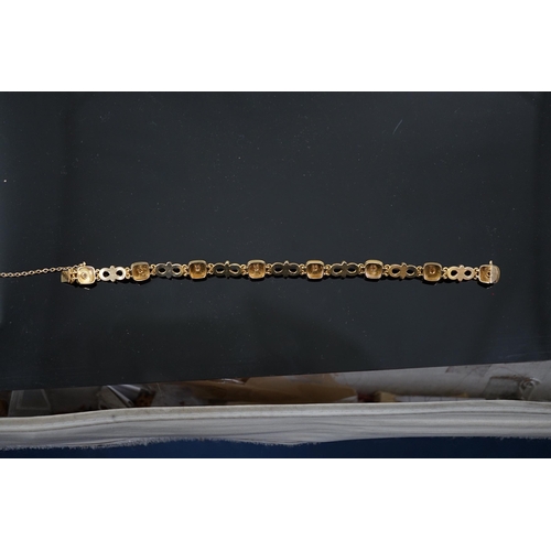 459 - An early 20th century gold (tests as 18ct), two colour enamel and spilt pearl set bracelet, with squ... 