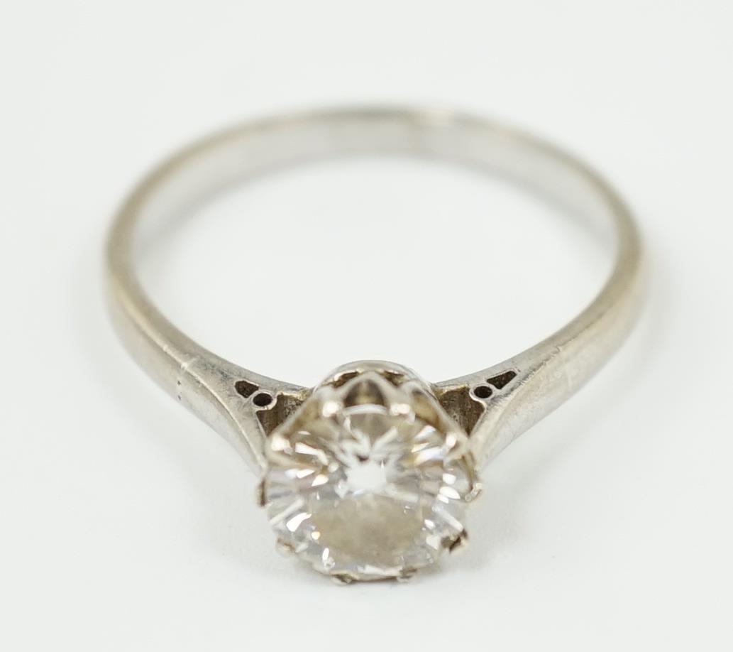 A white gold and solitaire diamond set ring, the stone weighing