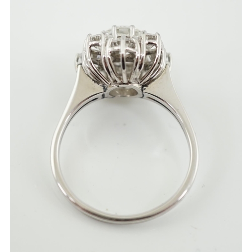 506 - A modern 18ct white gold and round brilliant cut nine stone diamond set cluster ring, the centre sto... 