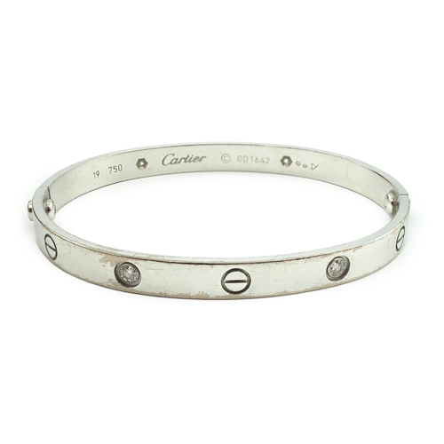 508 - A modern Cartier 750 white gold and four stone gypsy set diamond 'Love' bangle, signed and numbered ... 