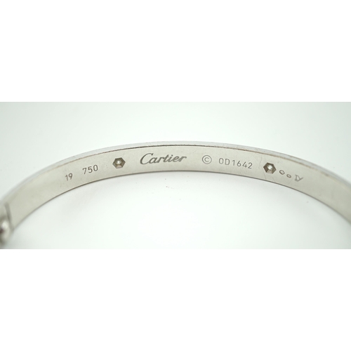 508 - A modern Cartier 750 white gold and four stone gypsy set diamond 'Love' bangle, signed and numbered ... 