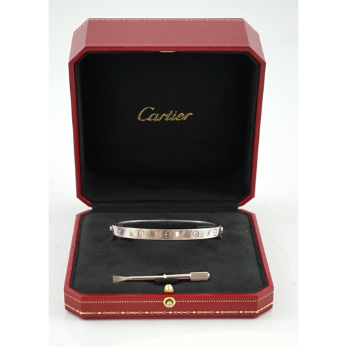 508 - A modern Cartier 750 white gold and four stone gypsy set diamond 'Love' bangle, signed and numbered ... 