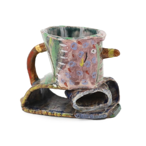 57 - § Angus Suttie (1946-1993), a multi coloured glazed earthenware vase, the bowl of the vessel support... 