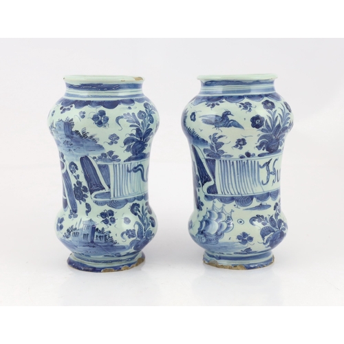 58 - A pair of Italian blue and white maiolica albarellos, Savona, late 17th century, the first painted w... 