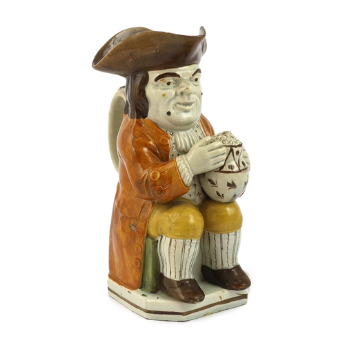 67 - A Staffordshire Prattware Toby jug, c.1790-1800, seated in standard pose holding a frothing beer mug... 