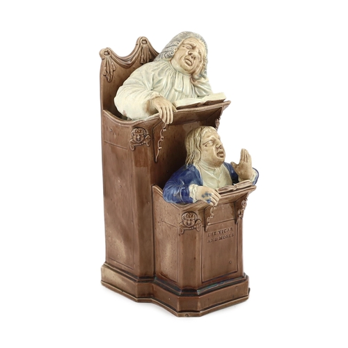 68 - A Ralph Wood type creamware Vicar and Moses group, c.1790, the two figures modelled standing in a pu... 