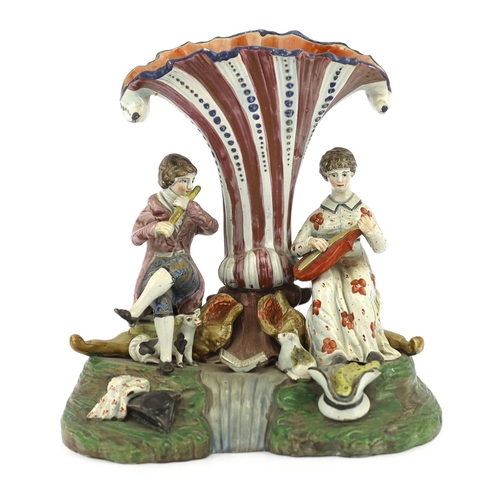 70 - A Staffordshire pearlware musical duet spill vase, c.1820, the figure of a gentleman playing the flu... 