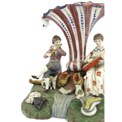 70 - A Staffordshire pearlware musical duet spill vase, c.1820, the figure of a gentleman playing the flu... 