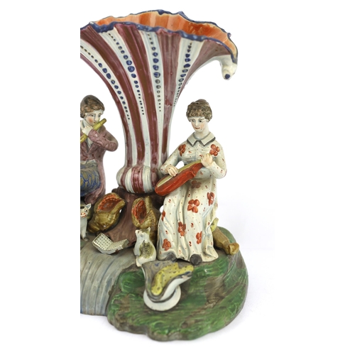 70 - A Staffordshire pearlware musical duet spill vase, c.1820, the figure of a gentleman playing the flu... 