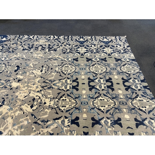 2062 - An Elizabeth Ashard 'Moghul', a silk and wool blue tones pattern carpet, 665 x 440cm