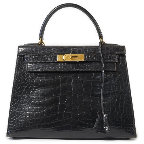 2269 - A vintage Hermès 28 Kelly in black alligator with gilt metalware, the bag has a square symbol near t... 