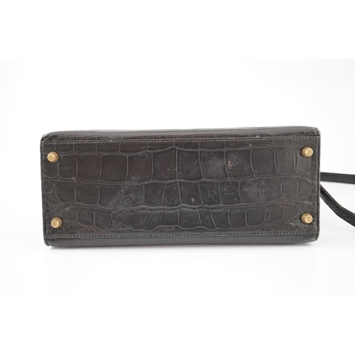 2269 - A vintage Hermès 28 Kelly in black alligator with gilt metalware, the bag has a square symbol near t... 