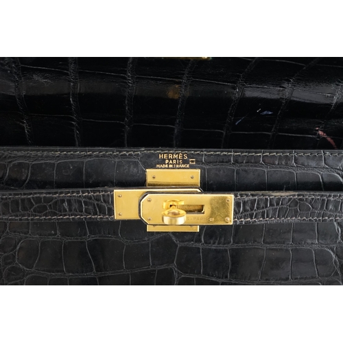 2269 - A vintage Hermès 28 Kelly in black alligator with gilt metalware, the bag has a square symbol near t... 