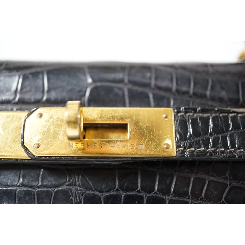 2269 - A vintage Hermès 28 Kelly in black alligator with gilt metalware, the bag has a square symbol near t... 