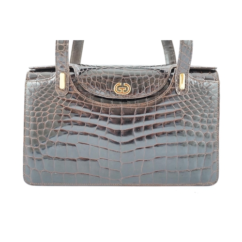 2295 - A lady's vintage brown crocodile handbag with gilt metalware.Please note that this American Alligato... 