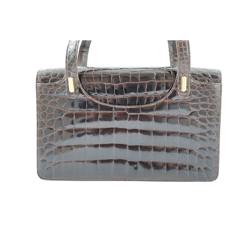 2295 - A lady's vintage brown crocodile handbag with gilt metalware.Please note that this American Alligato... 