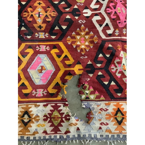 1063 - A Kilim polychrome flatweave carpet, approx. 400 x 380cm