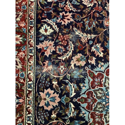 1074 - Two Tabriz blue ground rugs, larger 190 x 124cm