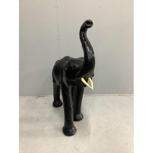 1076 - A large black leather covered model of an elephant, height 114cm