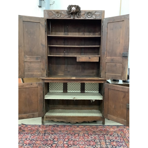 1085 - A 19th century Normandy pine marriage cupboard in two parts and carved with birds, width 141cm, dept... 