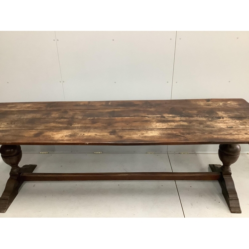 1100 - An 18th century style rectangular planked top oak refectory dining table, width 254cm, depth 84cm, h... 