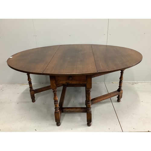 1112 - An 18th century style oak gateleg dining table, 170cm extended, depth 122cm, height 75cm together wi... 