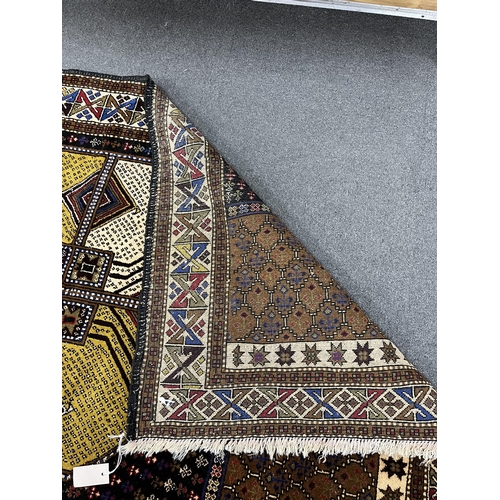 1185 - A Belouch geometric polychrome rug with central octagonal medallion, 202 x 113cm