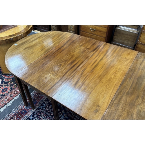 1195 - A George III mahogany D end extending dining table, 264cm extended, three spare leaves, width 121cm,... 