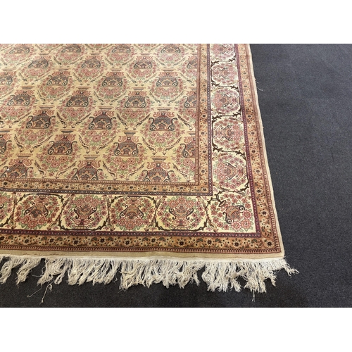 1217 - A North West Persian ivory ground carpet, woven with rows of flowering urns, 400 x 298cm