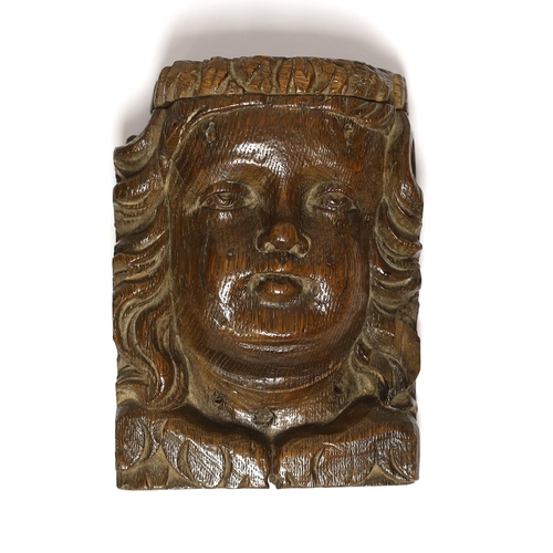 1412 - A 17th century carved oak figural terminal, 16cm high