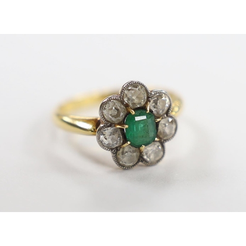 1981 - An 18ct, emerald and diamond set circular cluster ring, size L, gross weight 3.3 grams.