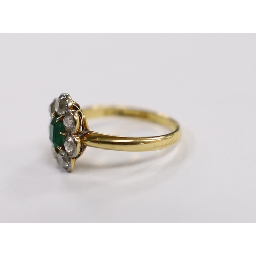 1981 - An 18ct, emerald and diamond set circular cluster ring, size L, gross weight 3.3 grams.