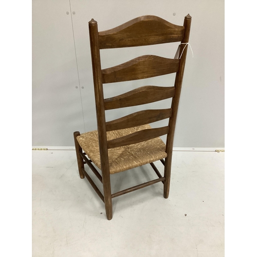 106 - An early 20th century Arts and Crafts ash rush seat ladderback nursing chair possibly by Edward Gard... 