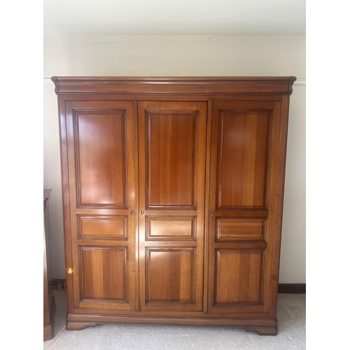 135 - A French style cherry five piece bedroom suite, comprising triple wardrobe, four drawer chest, tall ... 