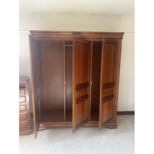 135 - A French style cherry five piece bedroom suite, comprising triple wardrobe, four drawer chest, tall ... 