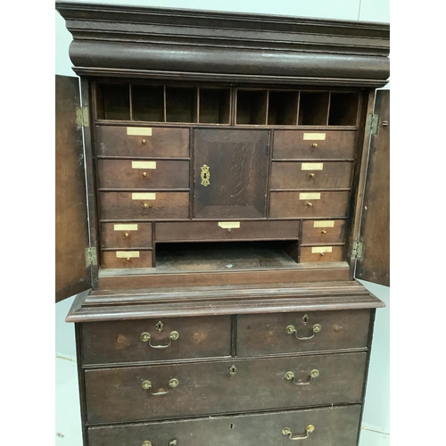 2 - An 18th century oak cabinet on chest, width 107cm, depth 52cm, height 178cm