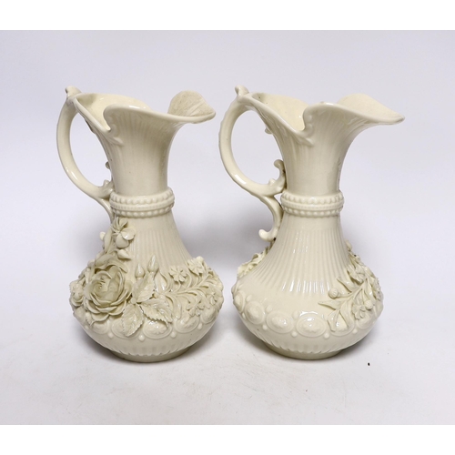 373 - A pair of Belleek jugs with applied rose decoration, 19 cm high