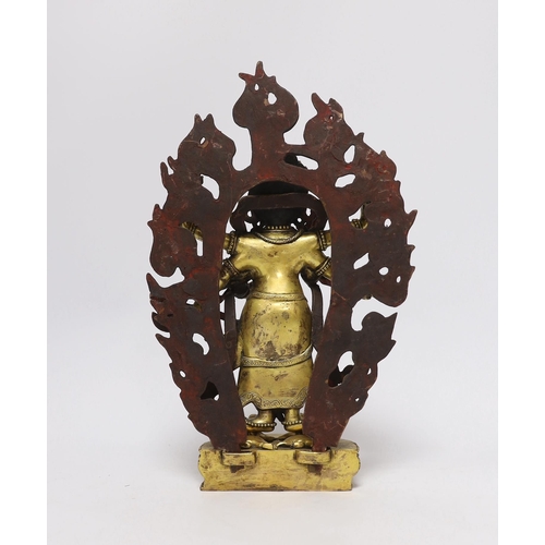 382 - A Sino-Tibetan gilt bronze figure of Mahakala with flame form mandala, 29cm high