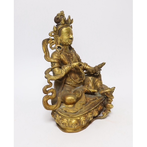 385 - A large Sino-Tibetan gilt bronze seated figure of Jambhala, 28cm high