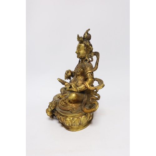 385 - A large Sino-Tibetan gilt bronze seated figure of Jambhala, 28cm high