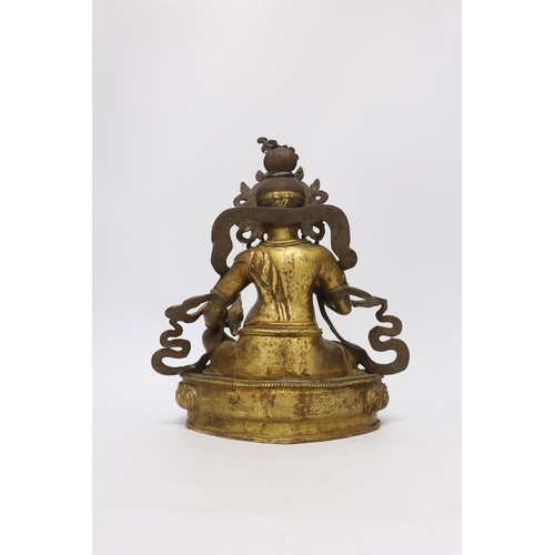 385 - A large Sino-Tibetan gilt bronze seated figure of Jambhala, 28cm high