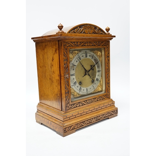 397 - An Edwardian carved oak mantel clock with engraved dial, 33cm high