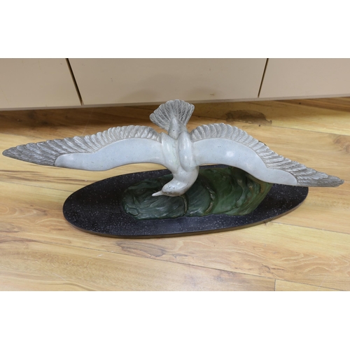 402 - M. Leducq, a painted spelter model of a gull in flight on marble base, 86cm wingspan