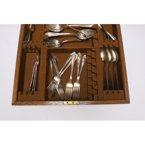 415 - An oak cased canteen containing Sheffield Super stainless flatware and a pair of plated candelabra... 