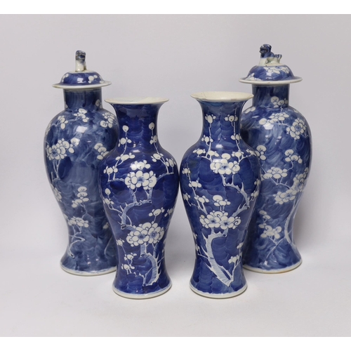 421 - Two pairs of late 19th/early 20th century Chinese blue and white prunus vases, one pair with covers,... 