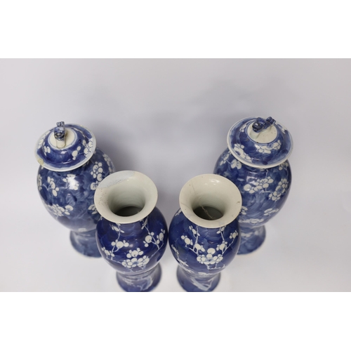 421 - Two pairs of late 19th/early 20th century Chinese blue and white prunus vases, one pair with covers,... 