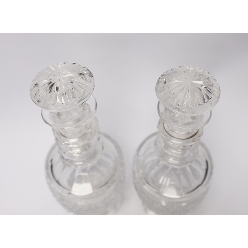 457 - A pair of mid 19th century cut glass decanters and stoppers, 29cm