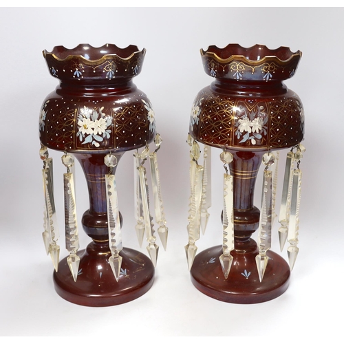 484 - A pair of late 19th century ruby glass floral enamelled table lustres, 35.5cm high