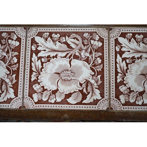 489 - A Victorian carved oak stand inset with there floral tiles, 69cm wide