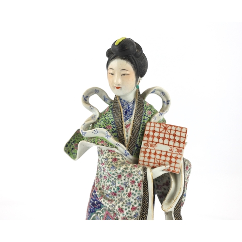 506 - A Chinese enamelled porcelain figure of a lady, Republic period, the standing figure of a lady weari... 